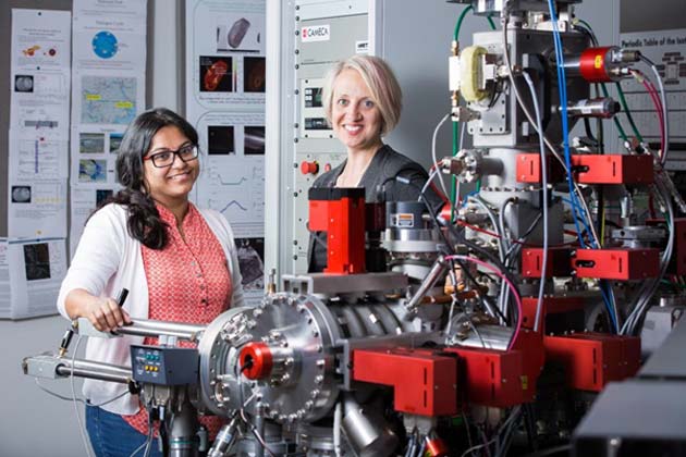 School of Earth and Space Exploration Assistant Professor Christy Till (right) and research assistant professor Maitrayee Bose stand with the NanoSIMS instrument. This advanced mass sprectrometer was a key ingredient in the volcanic crystal discovery because it lets scientists examine the elemental and isotopic composition of microscopic samples smaller than a human hair's thickness.