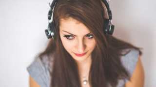  Young girl listening to music.